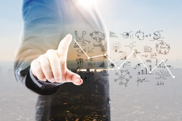 businessman-pointing-graphs-and-symbols_1232-917