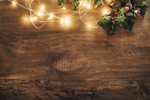 christmas-composition-with-mistletoe-and-string-lights_23-2147709886