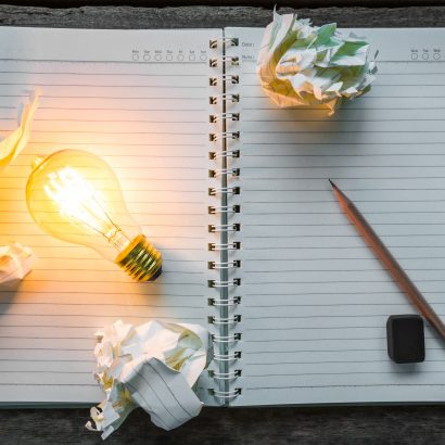 top-view-lit-light-bulb-notebook_1232-673