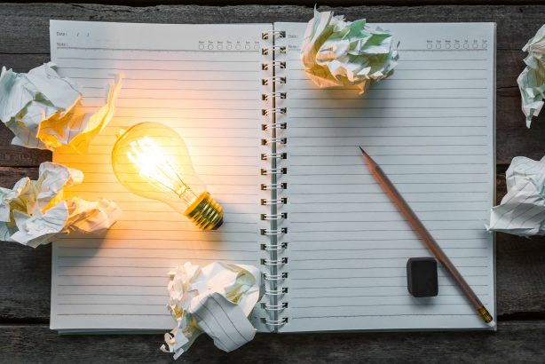 top-view-lit-light-bulb-notebook_1232-673